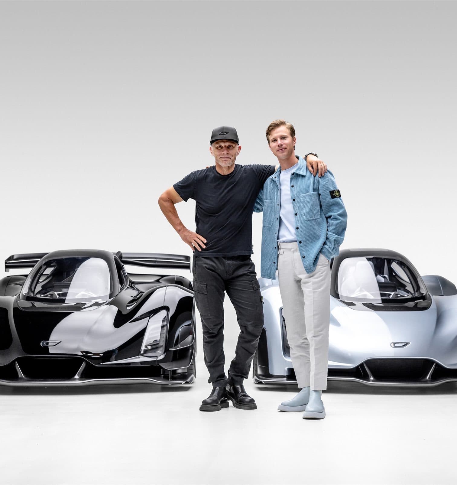 Kevin and Lukas Czinger standing between two Czinger 21Cs in the studio
